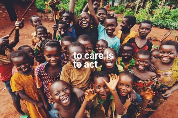 Joyful African children looking up and smiling with text 'to care is to act'.